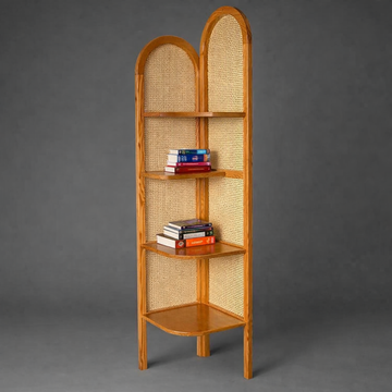 Arched wooden corner shelf mounted on a wall holding books — Bruinhout